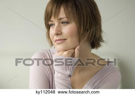 Stock Photo - Portrait of a young thinking woman. Fotosearch