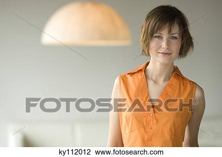 Stock Image - Portrait of a young woman looking at the camera. Fotosearch