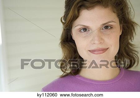 Portrait of a young woman looking at the camera View Large Photo Image Stock Image - Portrait of a young woman looking at the camera. Fotosearch