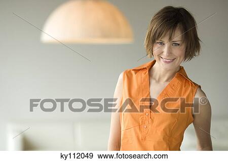 Stock Photo - Portrait of a young woman looking at the camera. Fotosearch