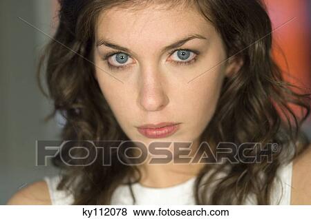 Stock Photo - Portrait of a young woman looking at the camera. Fotosearch