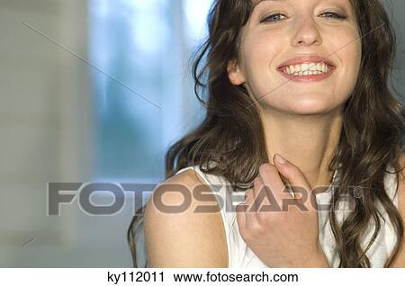 Stock Image - Portrait of a young woman smiling for the camera. Fotosearch