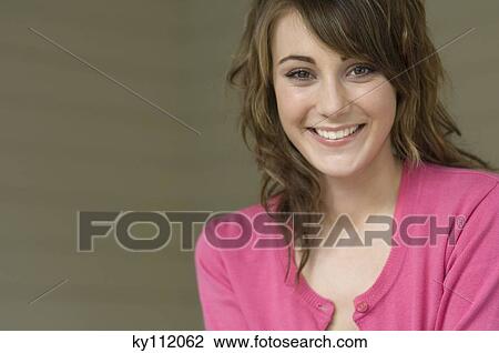 Stock Image - Portrait of a young woman smiling for the camera. Fotosearch