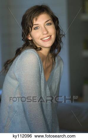 Stock Photograph - Portrait of a young woman smiling for the camera. Fotosearch