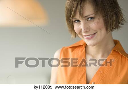 Portrait of a young woman smiling for the camera View Large Photo Image Stock Photography - Portrait of a young woman smiling for the camera. Fotosearch