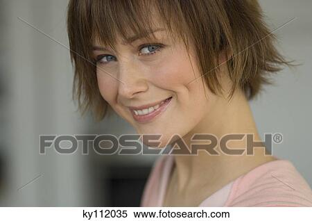 Stock Photography - Portrait of a young woman smiling. Fotosearch
