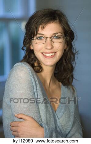 Stock Photo - Young smiling woman using laptop computer, holding credit card. Fotosearch