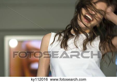 Young woman in white tank top, dancing, blurred motion View Large Photo Image Stock Photograph - Young woman in white tank top, dancing, blurred motion. Fotosearch