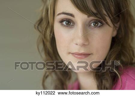 Young woman looking at the camera, close-up View Large Photo Image Stock Image - Young woman looking at the camera, close-up. Fotosearch