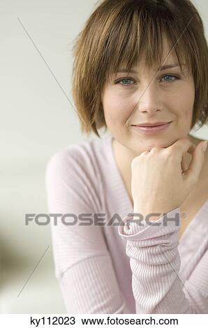 Stock Image - Young woman looking at the camera. Fotosearch
