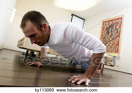 Man doing push-ups in bedroom View Large Photo Image Stock Photo - Man doing push-ups in bedroom. Fotosearch