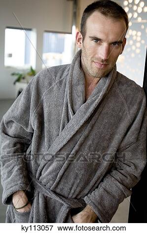 Man in grey bathrobe, leaning against wall, looking at the camera View Large Photo Image Stock Photo - Man in grey bathrobe, leaning against wall, looking at the camera. Fotosearch