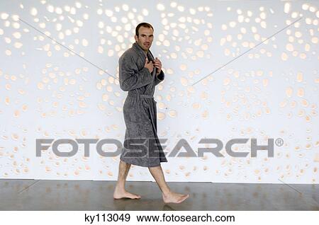 Man in grey bathrobe walking, looking at the camera View Large Photo Image Stock Photo - Man in grey bathrobe walking, looking at the camera. Fotosearch
