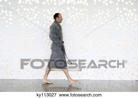 Man in grey bathrobe walking, side view View Large Photo Image Stock Photo - Man in grey bathrobe walking, side view. Fotosearch