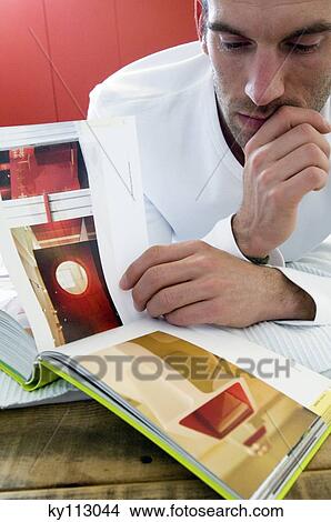 Man reading a book, close-up View Large Photo Image Picture - Man reading a book, close-up. Fotosearch