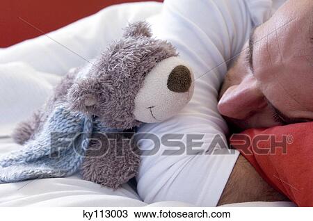Man sleeping with a teddy bear, close-up View Large Photo Image Stock Image - Man sleeping with a teddy bear, close-up. Fotosearch