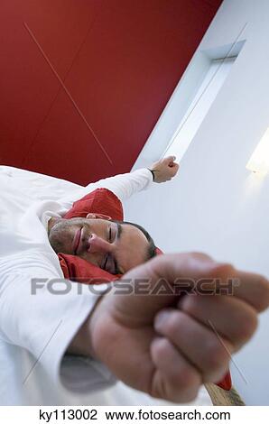 Man streching in bed View Large Photo Image Stock Image - Man streching in bed. Fotosearch