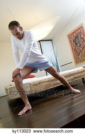 Man stretching in bedroom, low angle view View Large Photo Image Stock Image - Man stretching in bedroom, low angle view. Fotosearch