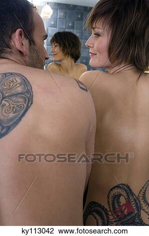 Tattooed couple, barechested, looking at each other in the bathroom, rear view View Large Photo Image Stock Image - Tattooed couple, barechested, looking at each other in the bathroom, rear view. Fotosearch