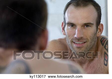 Tattooed man, barechested, in front of bathroom mirror View Large Photo Image Stock Photo - Tattooed man, barechested, in front of bathroom mirror. Fotosearch