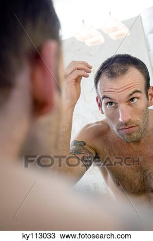 Tattooed man, barechested, looking in bathroom mirror View Large Photo Image Stock Image - Tattooed man, barechested, looking in bathroom mirror. Fotosearch