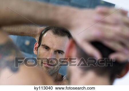 Tattooed man, barechested, looking in bathroom mirror View Large Photo Image Stock Image - Tattooed man, barechested, looking in bathroom mirror. Fotosearch