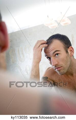 Tattooed man, barechested, looking in bathroom mirror View Large Photo Image Stock Photography - Tattooed man, barechested, looking in bathroom mirror. Fotosearch
