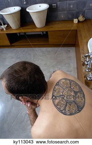 Tattooed man, barechested, sitting on tub edge, elevated view View Large Photo Image Stock Image - Tattooed man, barechested, sitting on tub edge, elevated view. Fotosearch
