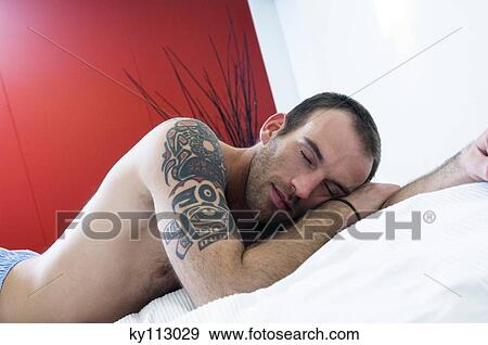 Tattooed man, barechested, sleeping in bed View Large Photo Image Stock Photo - Tattooed man, barechested, sleeping in bed. Fotosearch