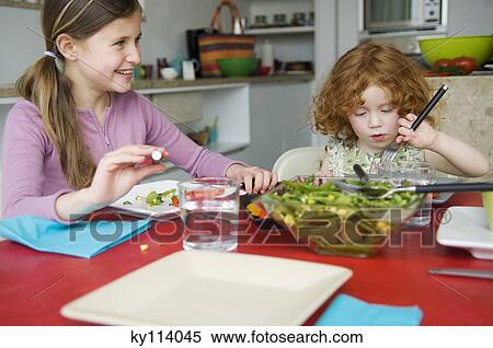 2 little girls at lunch table View Large Photo Image Stock Photography - 2 little girls at lunch table. Fotosearch