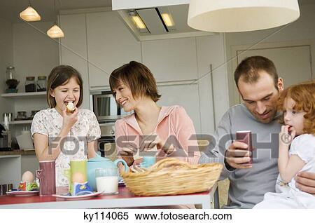 Couple and 2 little girls at breakfast table View Large Photo Image Stock Photography - Couple and 2 little girls at breakfast table. Fotosearch