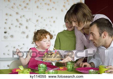 Couple and 2 little girls with birthday cake at lunch table View Large Photo Image Stock Photography - Couple and 2 little girls with birthday cake at lunch table. Fotosearch