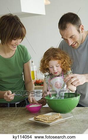 Couple and little girl cooking View Large Photo Image Picture - Couple and little girl cooking. Fotosearch