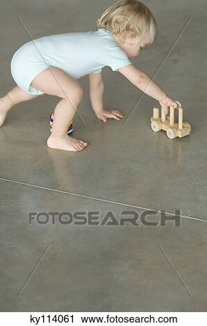 Little boy playing on the floor View Large Photo Image Stock Image - Little boy playing on the floor. Fotosearch