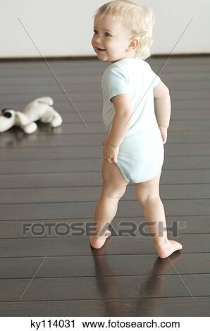 Little boy walking on wooden floor, rear view View Large Photo Image Stock Image - Little boy walking on wooden floor, rear view. Fotosearch