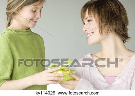Little girl giving present to woman View Large Photo Image Stock Photograph - Little girl giving present to woman. Fotosearch