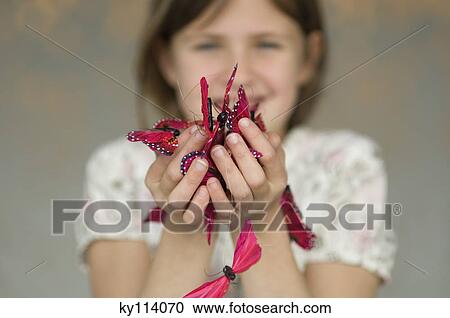 Little girl holding butterfly garland, close-up View Large Photo Image Stock Image - Little girl holding butterfly garland, close-up. Fotosearch