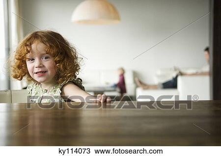 Little girl looking at the camera, coffee table in the foreground View Large Photo Image Stock Image - Little girl looking at the camera, coffee table in the foreground. Fotosearch