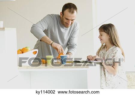 Little girl watching man squeezing oranges in the kitchen View Large Photo Image Stock Image - Little girl watching man squeezing oranges in the kitchen. Fotosearch