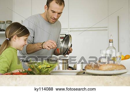 Stock Photo - Man and little girl cooking. Fotosearch