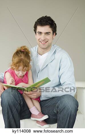 Man and little girl reading children's book View Large Photo Image Stock Photo - Man and little girl reading children's book. Fotosearch