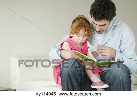 Man and little girl reading children's book View Large Photo Image Stock Photograph - Man and little girl reading children's book. Fotosearch