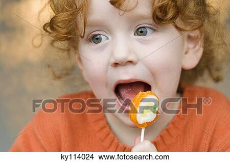 Portrait of a little girl eating lollipop View Large Photo Image Picture - Portrait of a little girl eating lollipop. Fotosearch