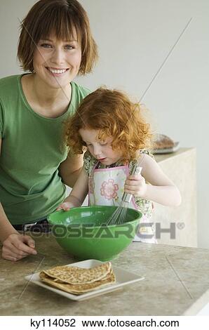 Smiling woman and little girl cooking View Large Photo Image Stock Image - Smiling woman and little girl cooking. Fotosearch