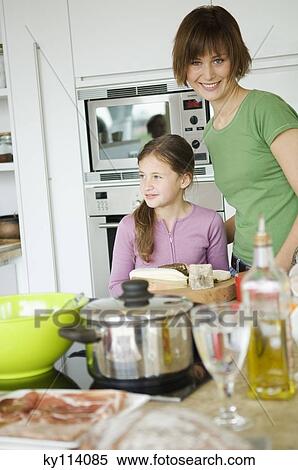 Woman and little girl in the kitchen View Large Photo Image Stock Photography - Woman and little girl in the kitchen. Fotosearch