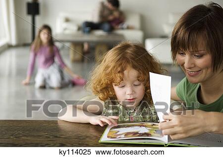 Woman and little girl reading a children's book View Large Photo Image Stock Photography - Woman and little girl reading a children's book. Fotosearch