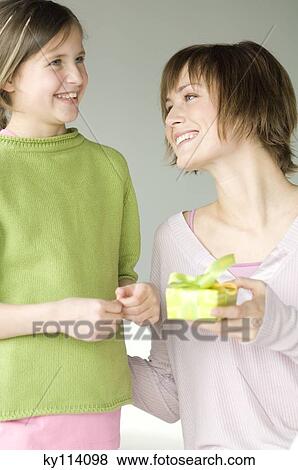 Stock Photo - Woman giving present to little girl. Fotosearch