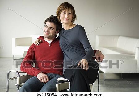 Couple embracing in a living-room View Large Photo Image Picture - Couple embracing in a living-room. Fotosearch