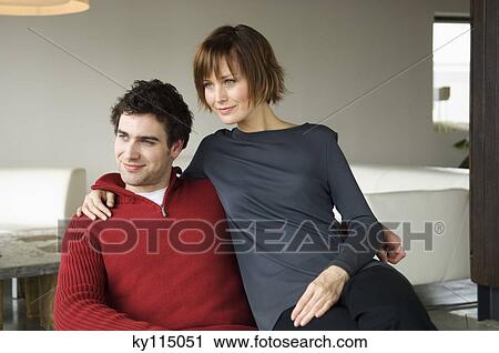 Couple embracing in a living-room View Large Photo Image Stock Image - Couple embracing in a living-room. Fotosearch