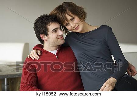Couple embracing in a living-room View Large Photo Image Stock Image - Couple embracing in a living-room. Fotosearch